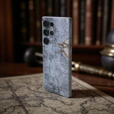 Phone case with map design mobile skin on a surface with books and globe in the background