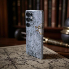 Phone case with map design mobile skin on a surface with books and globe in the background