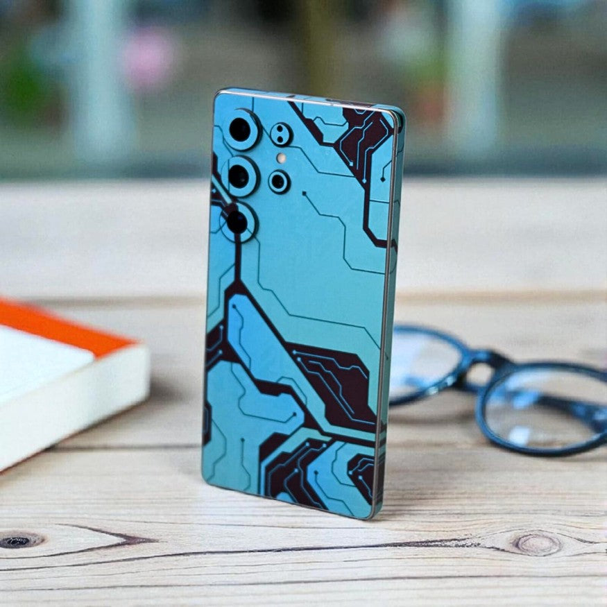 Circuit Phone Skin with blue and black abstract design on a wooden surface