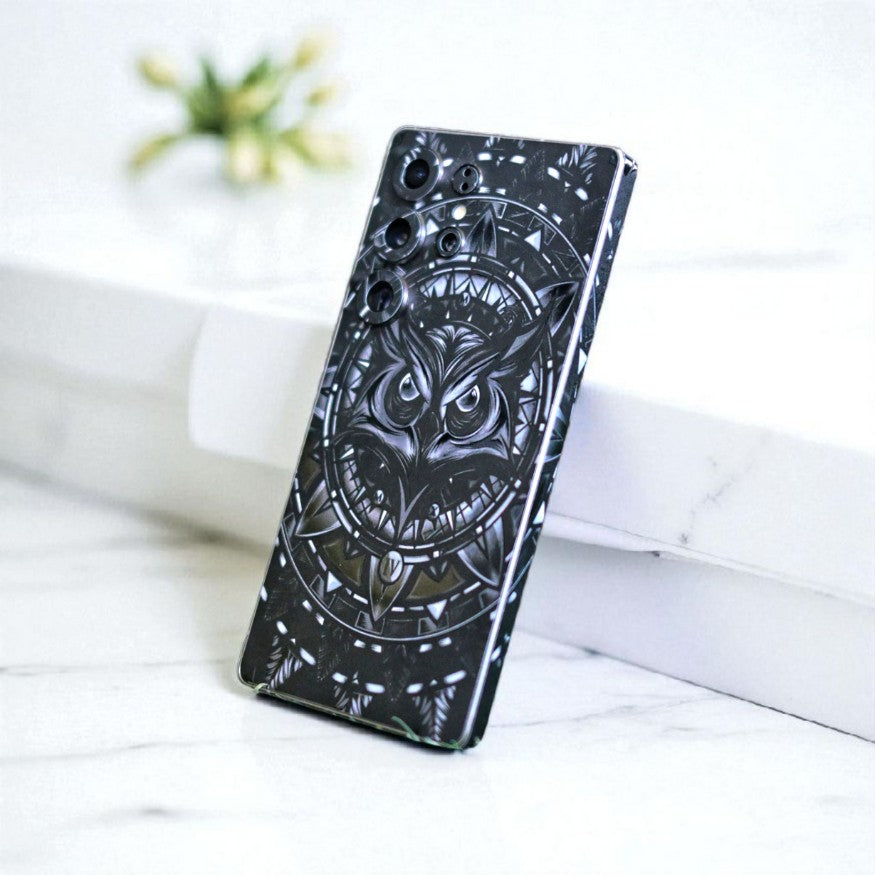 Phone skin with owl design on a white surface