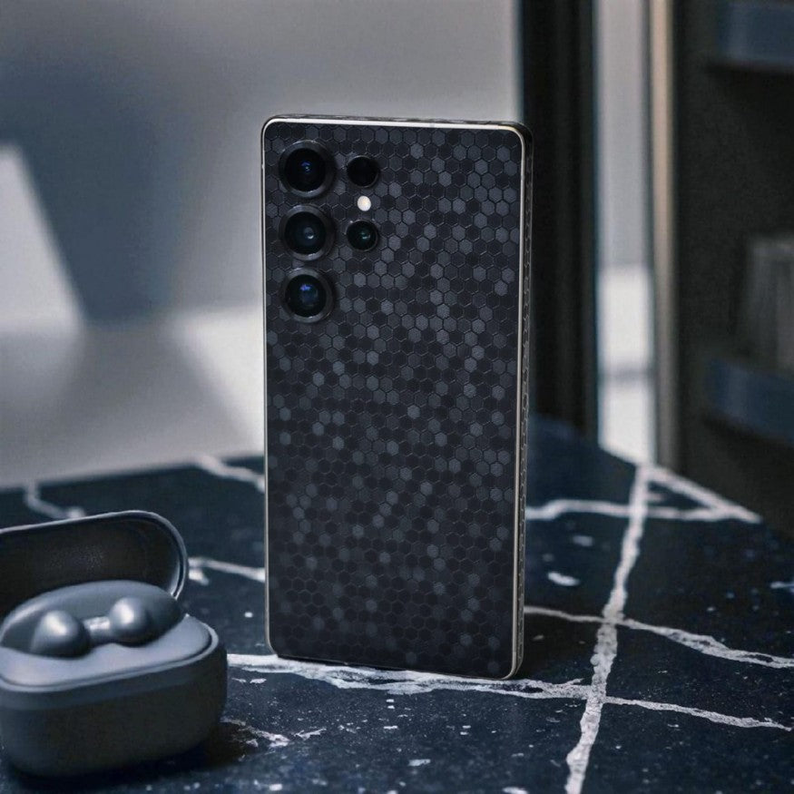 Smartphone with black honeycomb mobile skin on a dark surface Main image