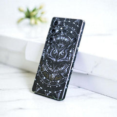 Phone skin with owl design on a white surface