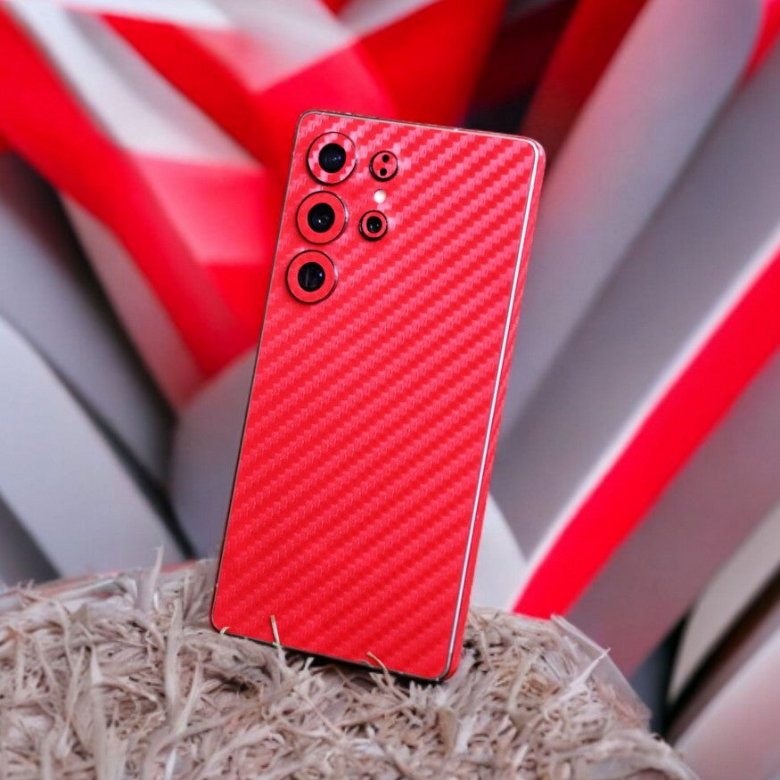 Smartphone with Red Carbon Fiber mobile skin on a dark surface